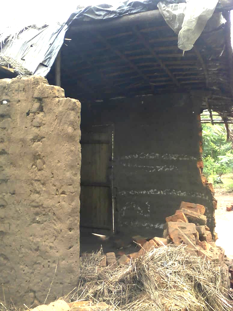 Profile of collapsed house Malawi village Bird Boy